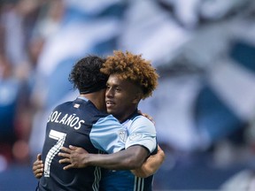 Vancouver’s Christian Bolanos and Yordy Reyna celebrate Reyna’s first-half goal against the Houston Dynamo during Saturday night’s 2-1 victory at B.C. Place. It was the second straight home win in which Reyna scored the deciding goal.