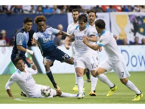 Whitecaps forward Yordi Reyna fights to get the ball past the Seattle Sounders.