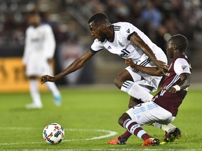 Vancouver Whitecaps' midfielder Tony Tchani fends off Colorado Rapids midfielder Michael Azira during Major League Soccer action at Dick's Sporting Goods Park on May 5.