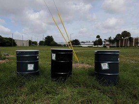 In this photo taken on Sept. 6, 2017 the Miami Drum Services Superfund site can be seen in a fenced off area behind a rail yard. At least five of the most flood-prone Superfund sites located in South Florida are in various stages of cleanup. Strong winds and driving rains from Irma could damage years of cleanup work completed at the sites and spread contamination, endangering public health by spreading the contamination. contamination. EPA said it was securing its Superfund sites in the area, bu