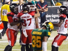 Calgary Stampeders&#039; Marquay McDaniel (16) celebrates his game-winning touchdown with Julan Lynch (85) Rory Kohlert (87), and Marken Michel (80) as Edmonton Eskimos&#039; Forrest Hightower leaves the field during second half CFL action in Edmonton, Alta., on Saturday September 9, 2017.THE CANADIAN PRESS/Amber Bracken
