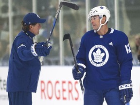 Toronto Maple Leafs head coach Mike Babcock, left, talks with forward Patrick Marleau during the team's first training-camp session in Niagara Falls, Ont., on Friday, Sept. 15, 2017.