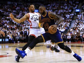 In this May 5 file photo, Toronto Raptors guard Norman Powell (left) defends against Cleveland Cavaliers forward LeBron James.