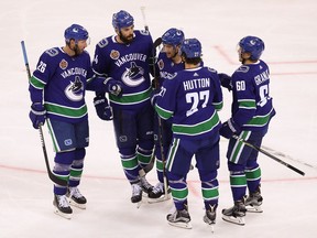 The Vancouver Canucks celebrate a goal during the pre-season game between the Los Angeles Kings and the Vancouver Canucks at Wukesong Arena on September 23, 2017 in Beijing, China.