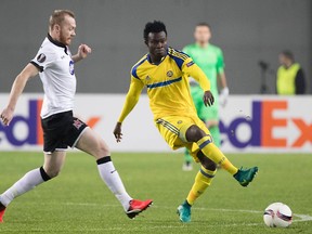 Maccabi Tel Aviv's Nigerian midfielder Nosa Igiebor (L) kicks the ball as Dundalk's Chris Shields (R) defends during the UEFA Europa League group D football match between Maccabi Tel Aviv and Dundalk at the Netanya Stadium in Netanya last December. Igiebor was signed by the Vancouver Whitecaps on Friday.