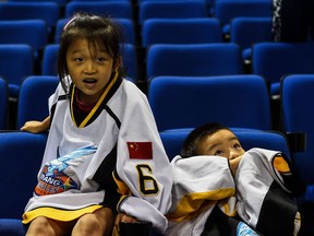 Chinese children learning ice hockey watch a practice session for the 2017 NHL China Games in Shanghai on September 19, 2017. The Los Angeles Kings and Vancouver Canucks will face each other starting September 21 for the first-ever preseason games played in China in the 2017 NHL China Games.