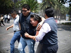 People react as a real quake rattles Mexico City on September 19, 2017 as an earthquake drill was being held in the capital.