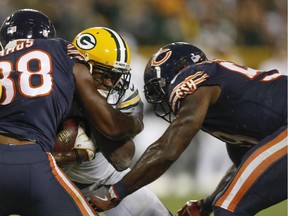 Green Bay Packers' Davante Adams is hit by Chicago Bears' Adrian Amos and Danny Trevathan during the second half of an NFL football game Thursday, Sept. 28, 2017, in Green Bay, Wis. The Bears were penalized on the play and Adams was taken off the field on a stretcher.