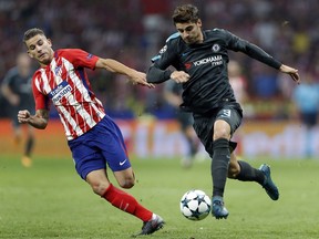 Atletico's Lucas, left, and Chelsea star Alvaro Morata challenge for the ball during a Champions League Group C soccer match in Madrid, Spain on Sept. 27, 2017.