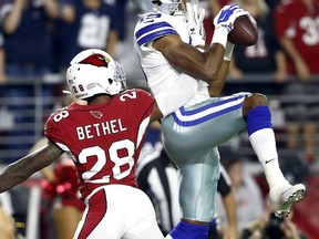 Dallas Cowboys wide receiver Brice Butler (19) pulls in a touchdown catch as Arizona Cardinals cornerback Justin Bethel (28) defends during the second half of an NFL football game, Monday, Sept. 25, 2017, in Glendale, Ariz. (AP Photo/Ross D. Franklin)