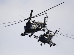 Two Belarusian military helicopters fly during military exercises, near the Volka village, 200 kilometres south-west of Minsk, Belarus, Tuesday, Sept. 19, 2017. The Zapad (West) 2017 military drills held jointly by Russian and Belarusian militaries at several firing ranges in both countries have rattled Russia's neighbours.