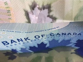 Canadian bank notes are seen Wednesday September 6, 2017 in Ottawa. The Bank of Canada is once again raising its benchmark interest rate as it sees the economy's powerful performance pointing to broader, more self-sustaining growth.