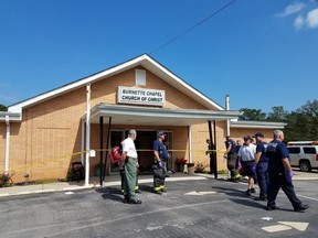 Police investigate after a gunman opened fire at Burnette Chapel Church or Christ in Nashville, Tenn.
