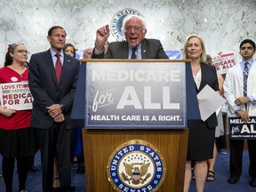 Sen. Bernie Sanders, I-Vt., center, joined by Sen. Richard Blumenthal, D-Conn., center left, Sen. Kirsten Gillibrand, D-N.Y., center right, and supporters, speaks at a news conference on Capitol Hill in Washington, Wednesday, Sept. 13, 2017, to unveil their Medicare for All legislation to reform health care. (AP Photo/Andrew Harnik)