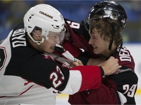 Vancouver Giants forward Tristyn Deroose (right) tangles with Aaron Boyd of the Prince George Cougars last season.