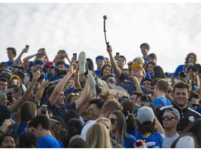 UBC president Santa Ono crowd-surfs during Saturday's Homecoming game at Thunderbird Stadium in Vancouver. A record 9,542 fans watched UBC beat the Saskatchewan Huskies 31-10.
