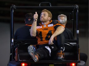 B.C. Lions' quarterback Travis Lulay gives fans a thumb's up as he's driven to the dressing room after leaving the game with an injury during the first half of a CFL football game against the Montreal Alouettes in Vancouver on Friday.