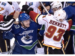 Vancouver Canucks' Derek Dorsett winds up for a hit to Calgary Flames' Sam Bennett during NHL action last October. Dorsett expects to be doing much the same this season for the Canucks.