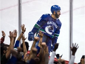 Darren Archibald of the Vancouver Canucks celebrates his third-period goal against the Calgary Flames on Thursday in NHL pre-season action at Rogers Arena in Vancouver. The Canucks won 3-1.
