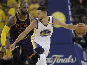 Golden State Warriors guard Stephen Curry (30) is guarded by Cleveland Cavaliers forward LeBron James during the second half of Game 1 of basketball's NBA Finals in Oakland, Calif., Thursday, June 1, 2017.