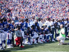 Buffalo Bills players kneel during the American National anthem before an NFL game against the Denver Broncos on September 24, 2017 at New Era Field in Orchard Park, New York.