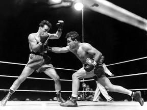 A June 16, 1949, photo shows Jake LaMotta, right, fighting Marcel Cerdan in Briggs Stadium in Detroit, Mich., to become the new world middleweight champion.