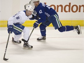 Evan McEneny battles with Alex Burmistrov in Canucks training camp.