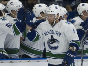 Vancouver Canucks Jonah Gadjovich celebrates with the team after scoring against the Winnipeg Jets on Friday, Sept. 8.