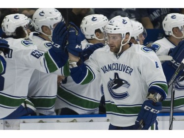 Vancouver Canucks Jonah Gadjovich celebrates with the team after scoring against the Winnipeg Jets on Friday, Sept. 8.