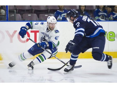 Vancouver Canucks Jonah Gadjovich (43) tries to get past Winnipeg Jets Antoine Crete-Belzile.