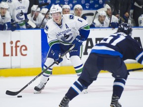 Vancouver Canucks' Brock Boeser, left, looks to take a shot on goal while being defended by Winnipeg Jets' Luke Green during NHL pre-season action at the Young Stars Classic at the South Okanagan Events Centre in Penticton on Sept, 8.