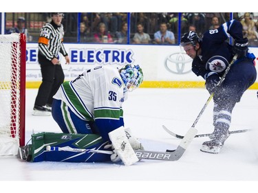 Vancouver Canucks goalie Thatcher Demko (left) stops Winnipeg Jets Kameron Kielly.