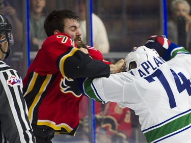 Calgary Flames Hunter Smith (left) and Vancouver Canucks Yan-Pavel Laplante fight during NHL preseason hockey action at the Young Stars Classic