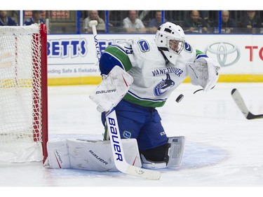 Vancouver Canucks goalie Michael DiPietro makes a save off a Calgary Flames shot.