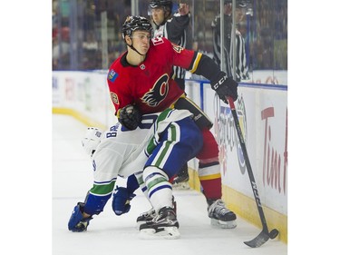 Calgary Flames Zach Fischer (right) reacts as he is about to get hit by Vancouver Canucks Matt Barberis.