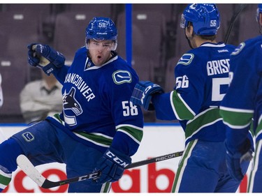 Vancouver Canucks Michael Carcone (left) celebrates with Guillaume Brisebois after scoring a goal against the Edmonton Oilers.