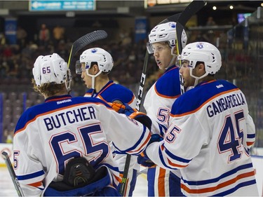 Edmonton Oilers Ostap Safin (middle) celebrates with teammates Chad Butcher (left) and Joe Gambardella after scoring a goal against the Vancouver Canucks.