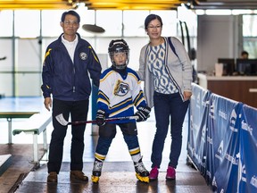 Seven-year-old Daniel Luk with his parents, Colin Luk and Shuying Kong. Daniel has been playing, and enjoying hockey, for two years.