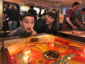 Lincoln Reid and his mother Michelle Reid in action at The Vancouver FlipOut Pinball Expo on Sunday.