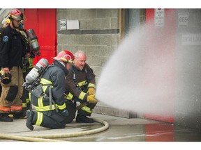 B.C. Premier John Horgan goes through a mini training session as part of the B.C. Professional Firefighters Fire Ops program at the Vancouver Training Center in Vancouver, B.C., September 25, 2017.