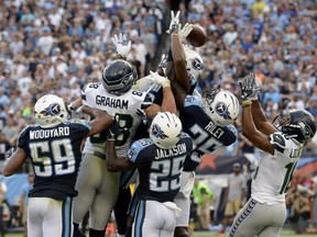Seattle Seahawks tight end Jimmy Graham (88) and wide receiver Tyler Lockett (16) reach for a pass with Tennessee Titans defenders in the end zone during the second half of an NFL football game, Sunday, Sept. 24, 2017, in Nashville, Tenn.