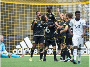 Kekuta Manneh gets hoisted in the air by teammates after scoring the Crew's second goal on Saturday against his old team.