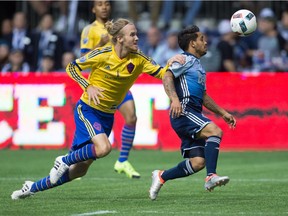 Vancouver Whitecaps' Cristian Techera, right, is taken down by Colorado Rapids' Jared Watts, leading to a penalty kick that Techera scored on during their game last year at B.C. Place.