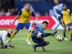 Vancouver Whitecaps' Fredy Montero, right, tries to direct a shot during the 2-1 win over the Colorado Rapids' on Saturday. He will return to Seattle Wednesday, to play a Sounders team that gave him his MLS start.