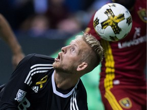 The ball bounces over Vancouver Whitecaps' goalkeeper David Ousted's head and enters the net for a goal by Real Salt Lake's Chris Wingert, not seen, during first half MLS soccer action at B.C. Place on Saturday.
