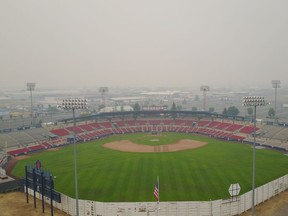 Avista Stadium in Spokane is shrouded in smoke from wildfires Tuesday. The first game of the Northwest League North Division baseball playoffs between the Spokane Indians and Vancouver Canadians was postponed Tuesday due to poor air quality. The best-of-three series will be played entirely in Vancouver.