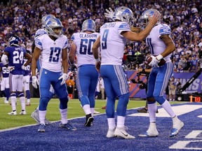 Marvin Jones of the Detroit Lions celebrates with Matthew Stafford after scoring a 27 yard touchdown in the first quarter against the New York Giants during their game at MetLife Stadium on September 18, 2017 in East Rutherford, New Jersey.