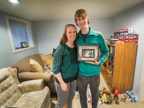 Sabrina and Nathan Drover with their returned possessions, including their framed wedding picture, at their new home in Vancouver, B.C., September 25, 2017.