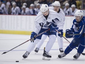 Team White's Kole Lind moves the pick against Team Blue in the Canucks Summer Showdow Top Prospect game at Rogers Arena in July