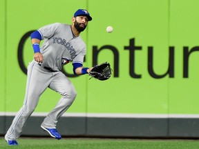 Jose Bautista catches a fly ball against the Minnesota Twins on Sept. 14.